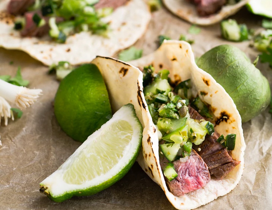 Beef tacos and lime on a table