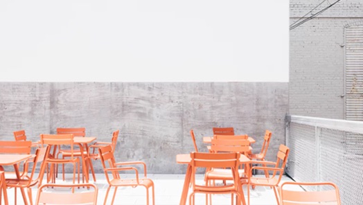 Tables and chairs in a empty restaurant